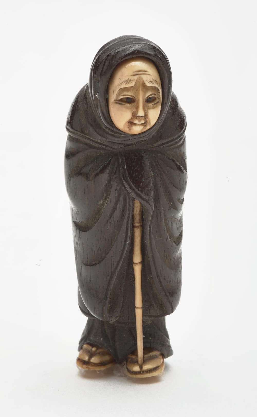 a miniature sculpture of a Fox Priest made of carved wood and ivory.
